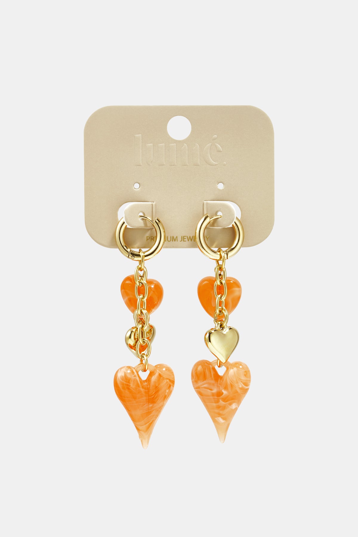 Earrings with dangling hearts on a chain